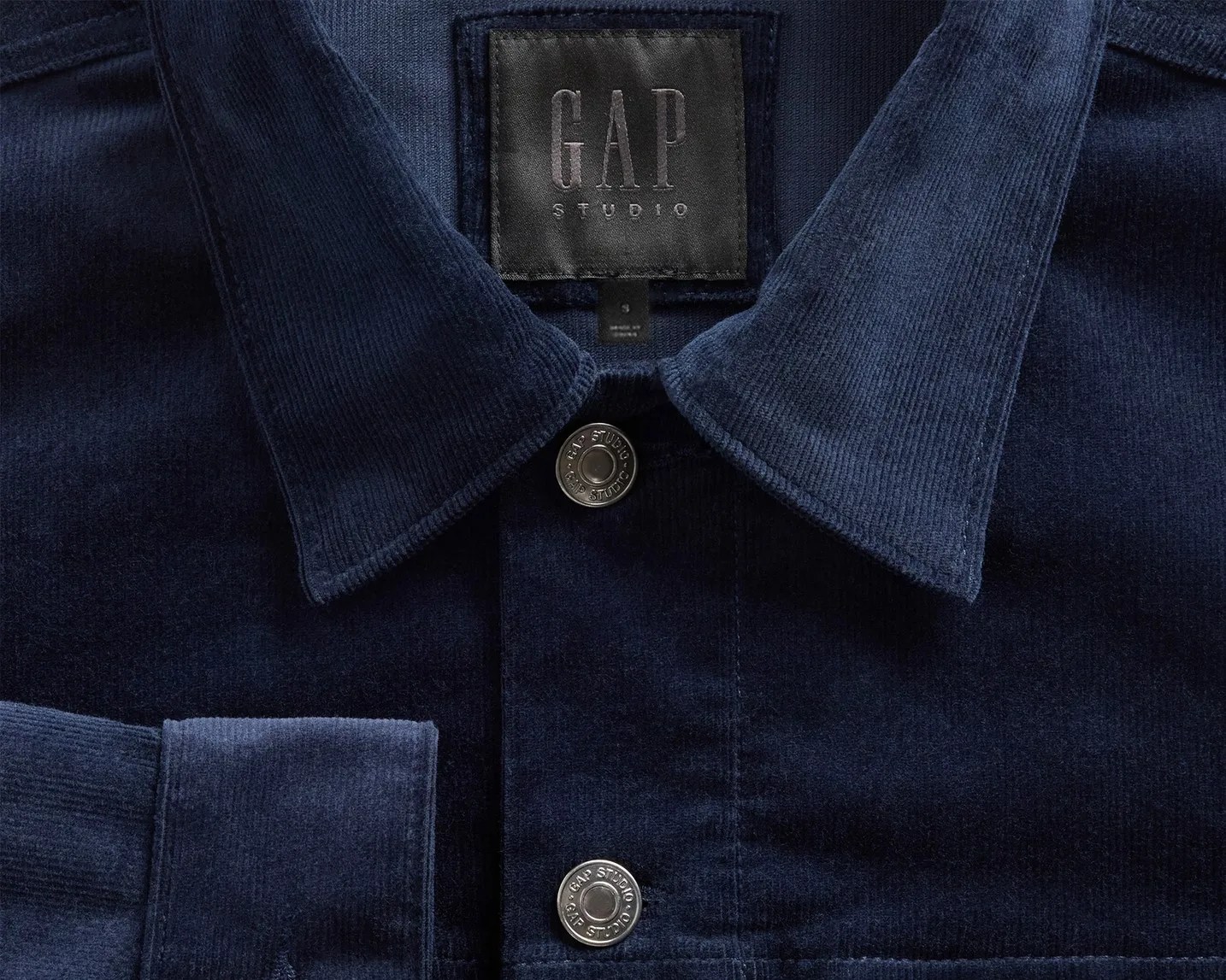 Navy blue corduroy shirt with a collar and metal buttons labeled "GAP Studio.