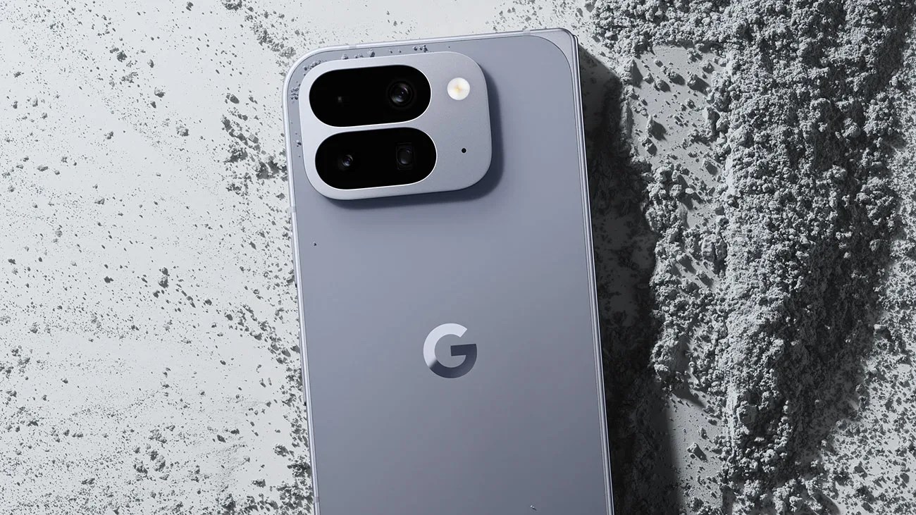Gray Google smartphone with dual rear cameras and flash on a textured gray surface.