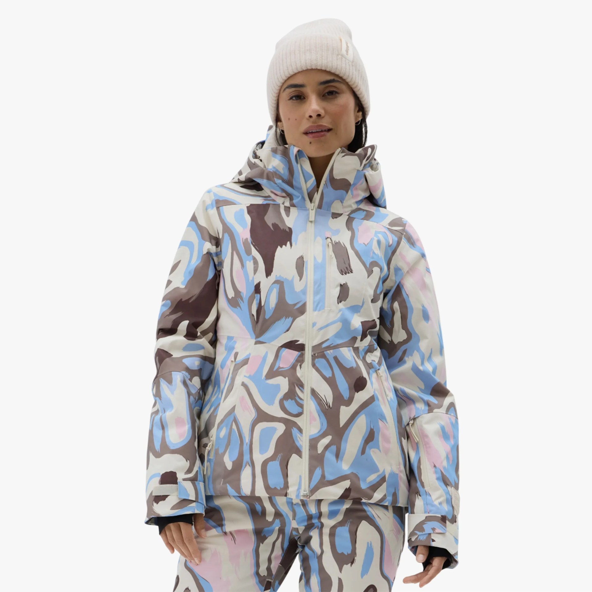 Woman wearing a multicolored abstract-patterned winter jacket with a high collar and matching pants.