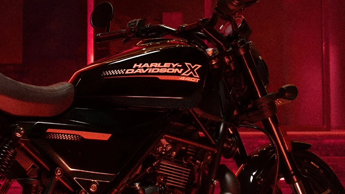 Black Harley-Davidson motorcycle fuel tank with "Harley-Davidson X 340T" logo in red lighting.