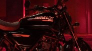 Black Harley-Davidson motorcycle fuel tank with "Harley-Davidson X 340T" logo in red lighting.