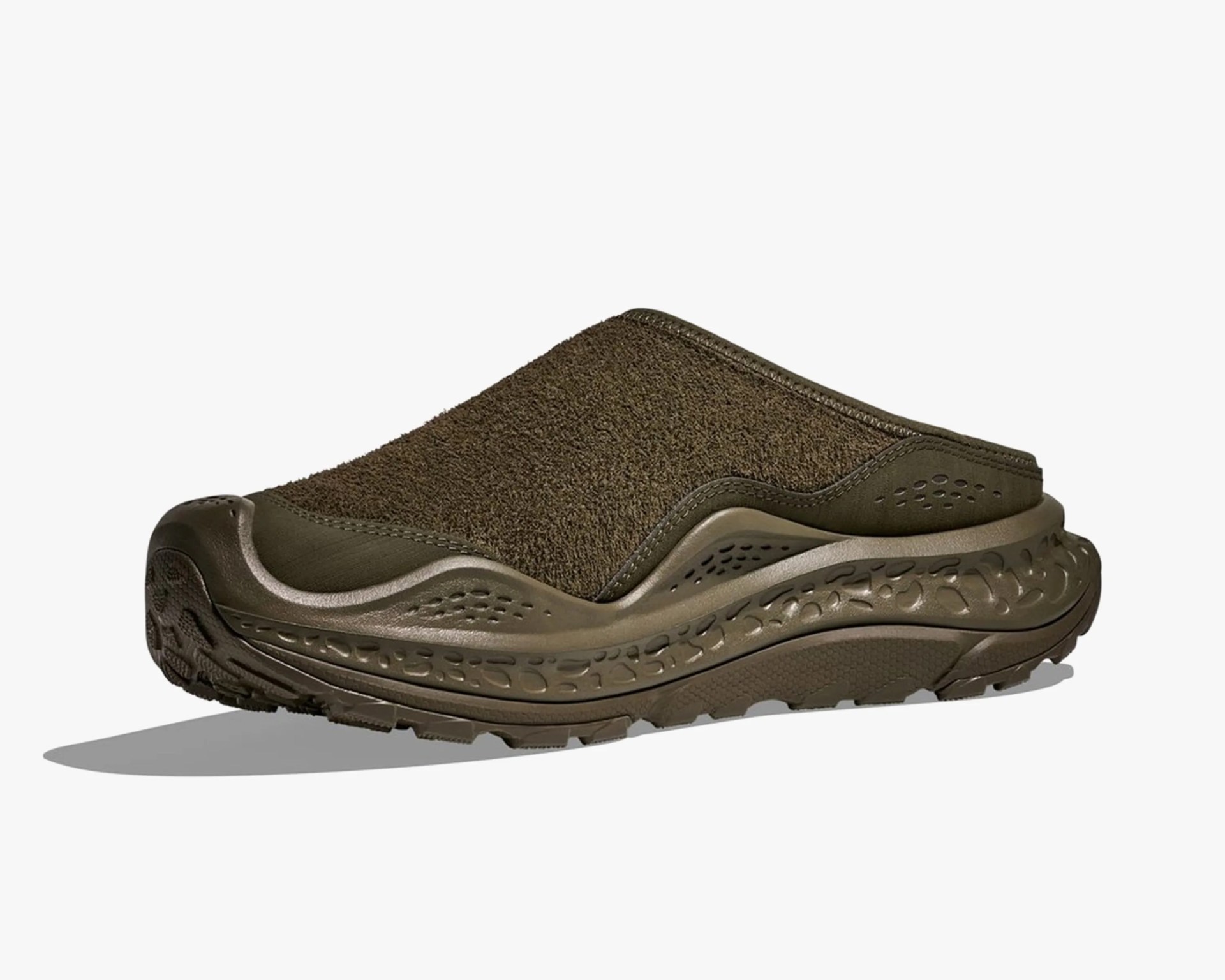 Olive green slip-on clog with textured upper and thick patterned sole.
