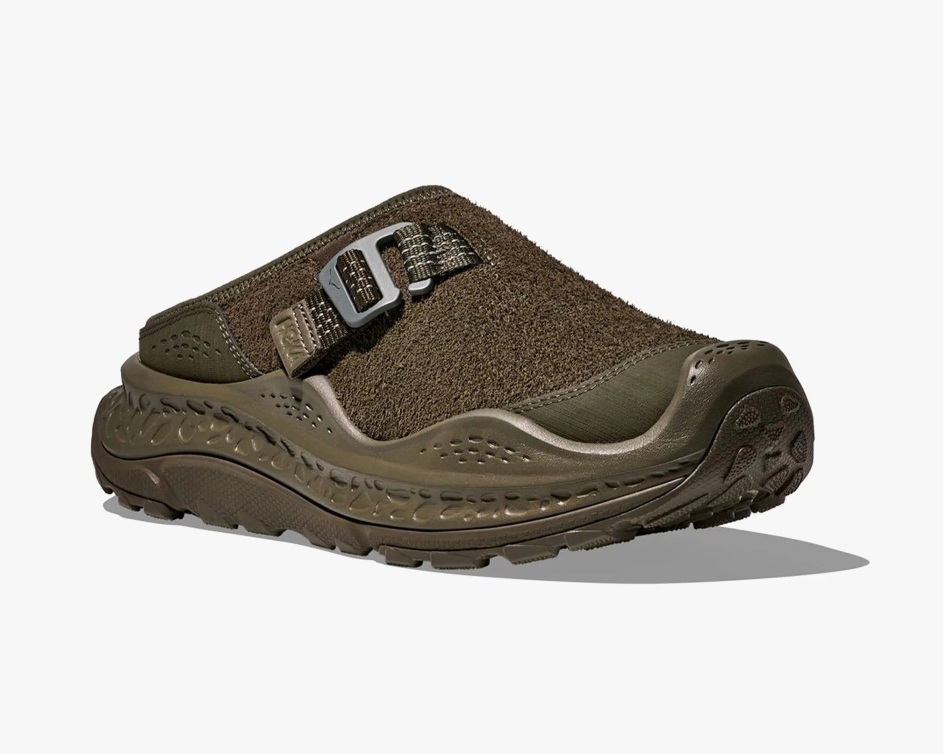 Olive green slip-on clog with textured upper, adjustable strap, and thick patterned sole.