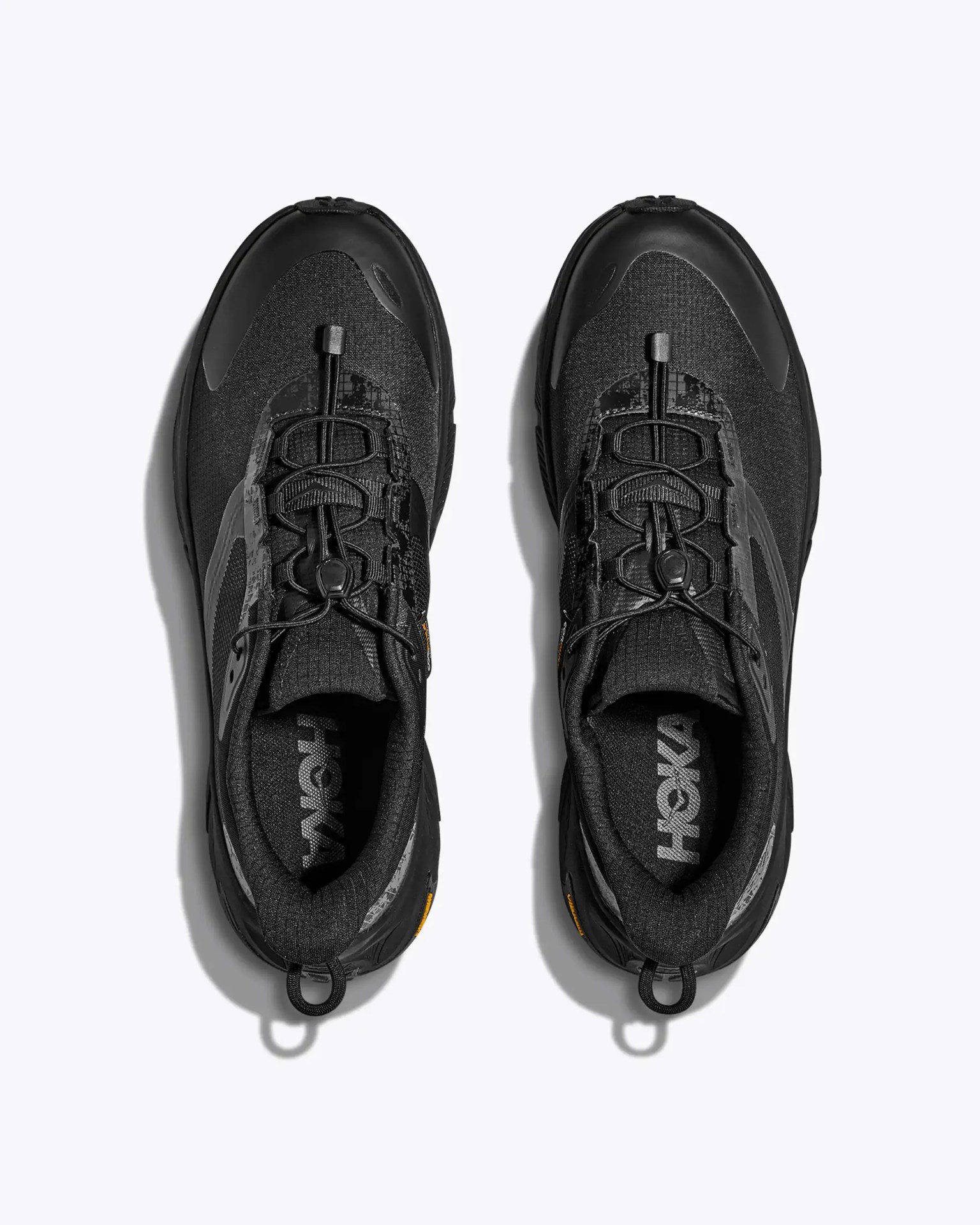 Pair of black Hoka running shoes with quick-pull laces viewed from above on a white background.