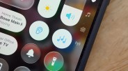 Close-up of a smartphone screen showing music and sound control icons on a dark background.