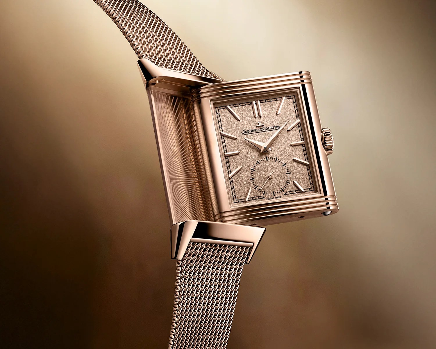 Rose gold Jaeger-LeCoultre rectangular watch with mesh bracelet and reversible case open.