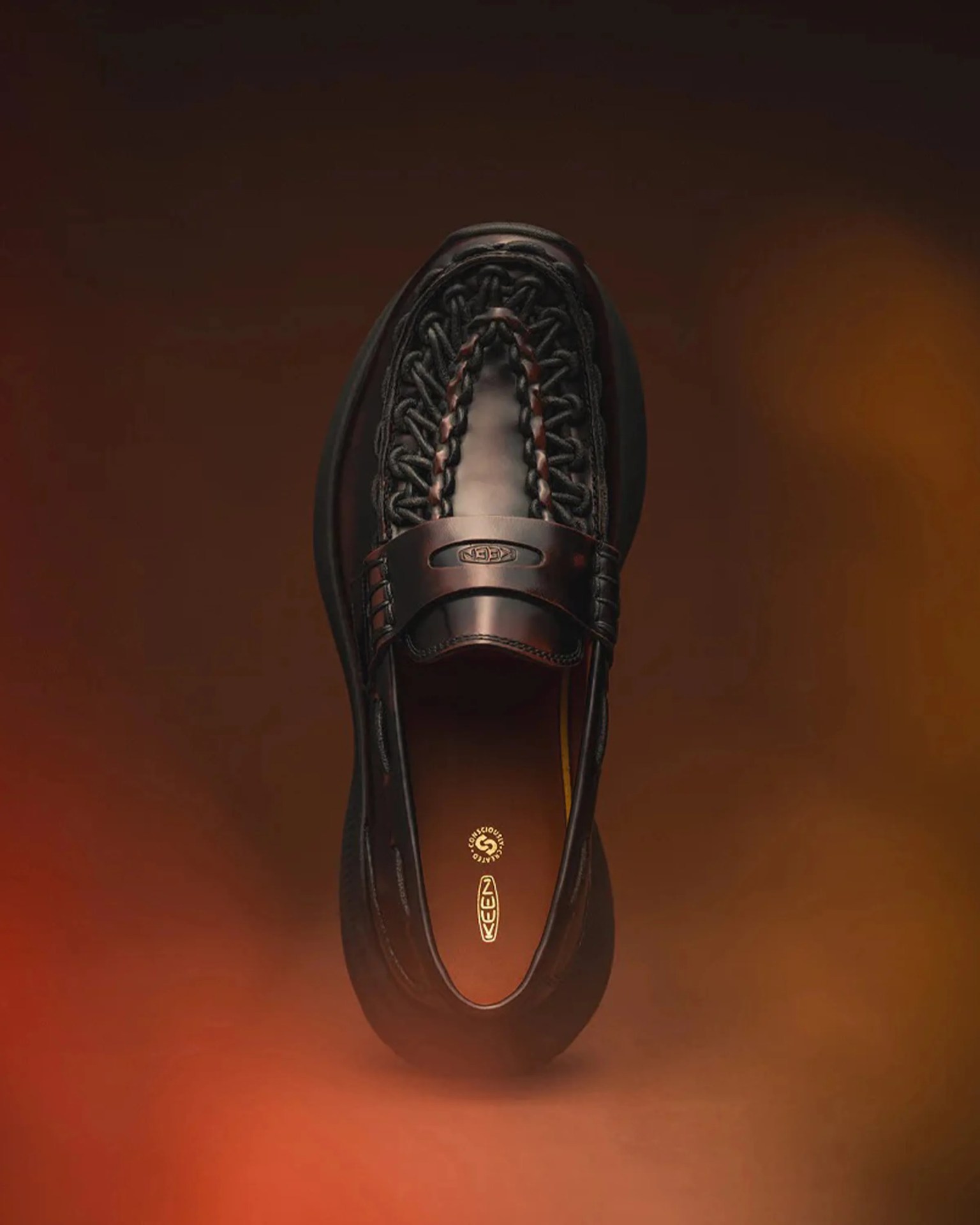 Black woven leather slip-on shoe with a thick sole and KEEN logo on the insole.