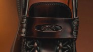 Close-up of dark brown leather Keen shoe with visible logo on the strap.