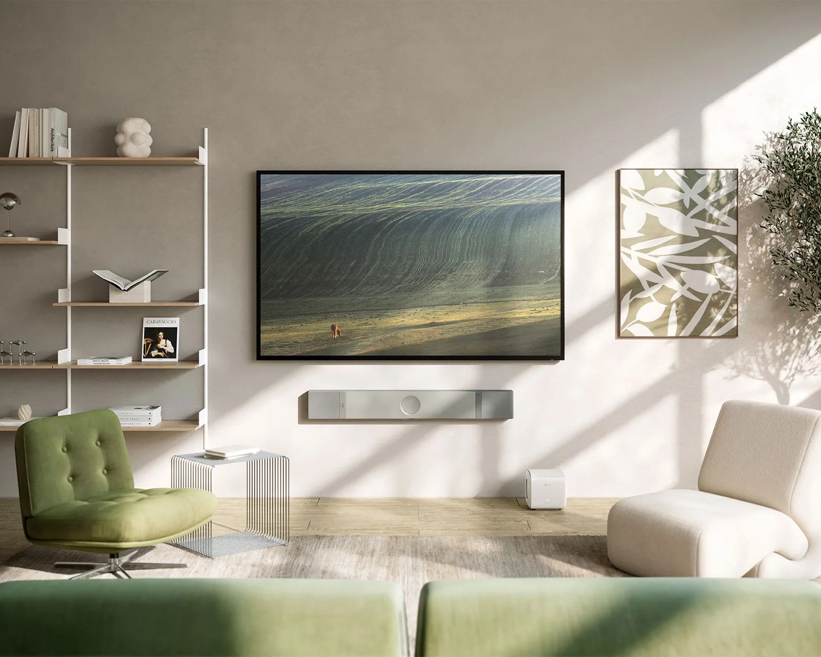 Modern living room with a wall-mounted flat-screen TV, green and white chairs, a wireframe side table, and a wooden shelf unit.