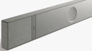 Gray KEF soundbar with fabric-covered speakers and a circular speaker grille on a white background.
