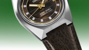 Close-up of a King Seiko watch with a brown textured dial, gold accents, stainless steel case, and dark brown leather strap.