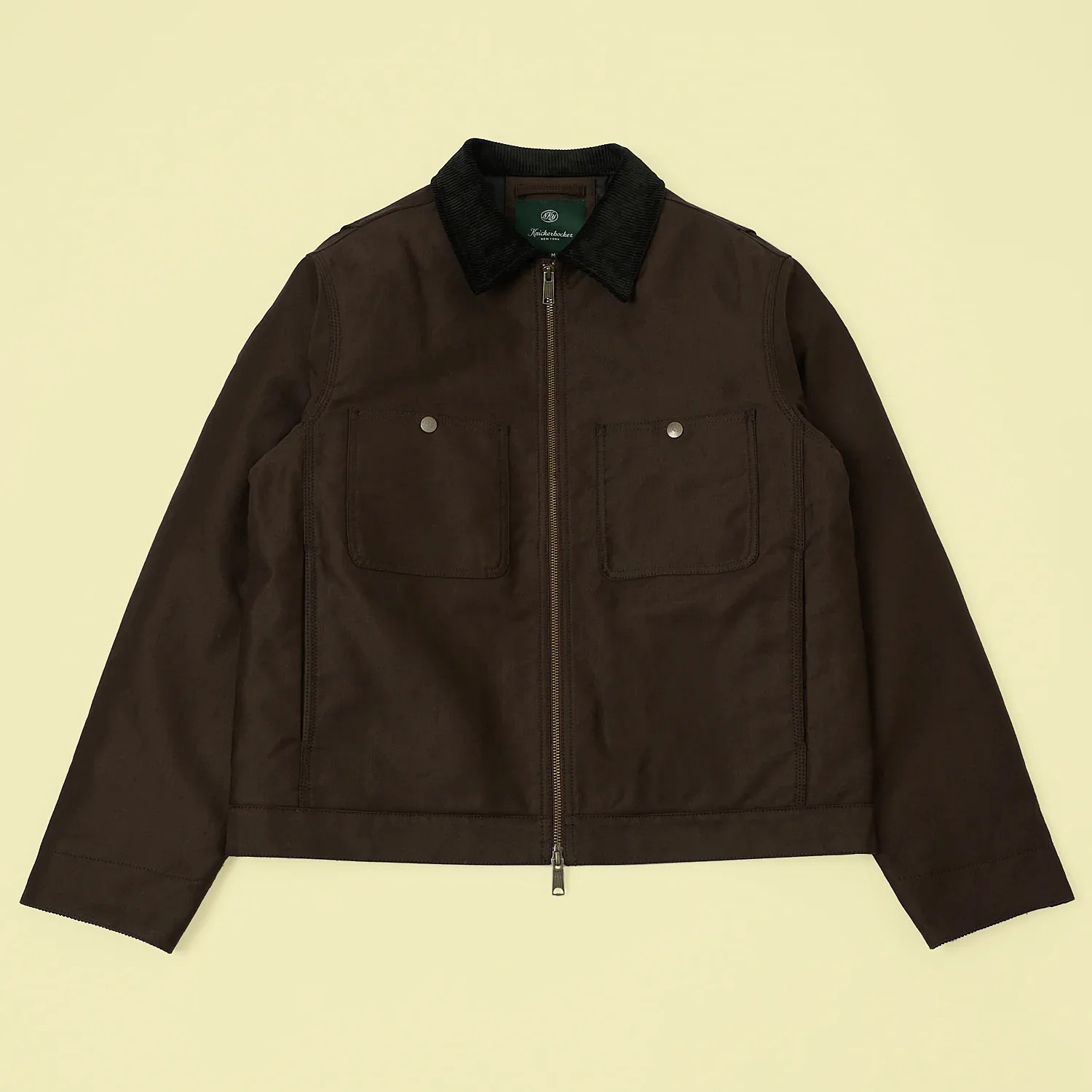 Dark brown zip-up jacket with black corduroy collar and two front flap pockets.