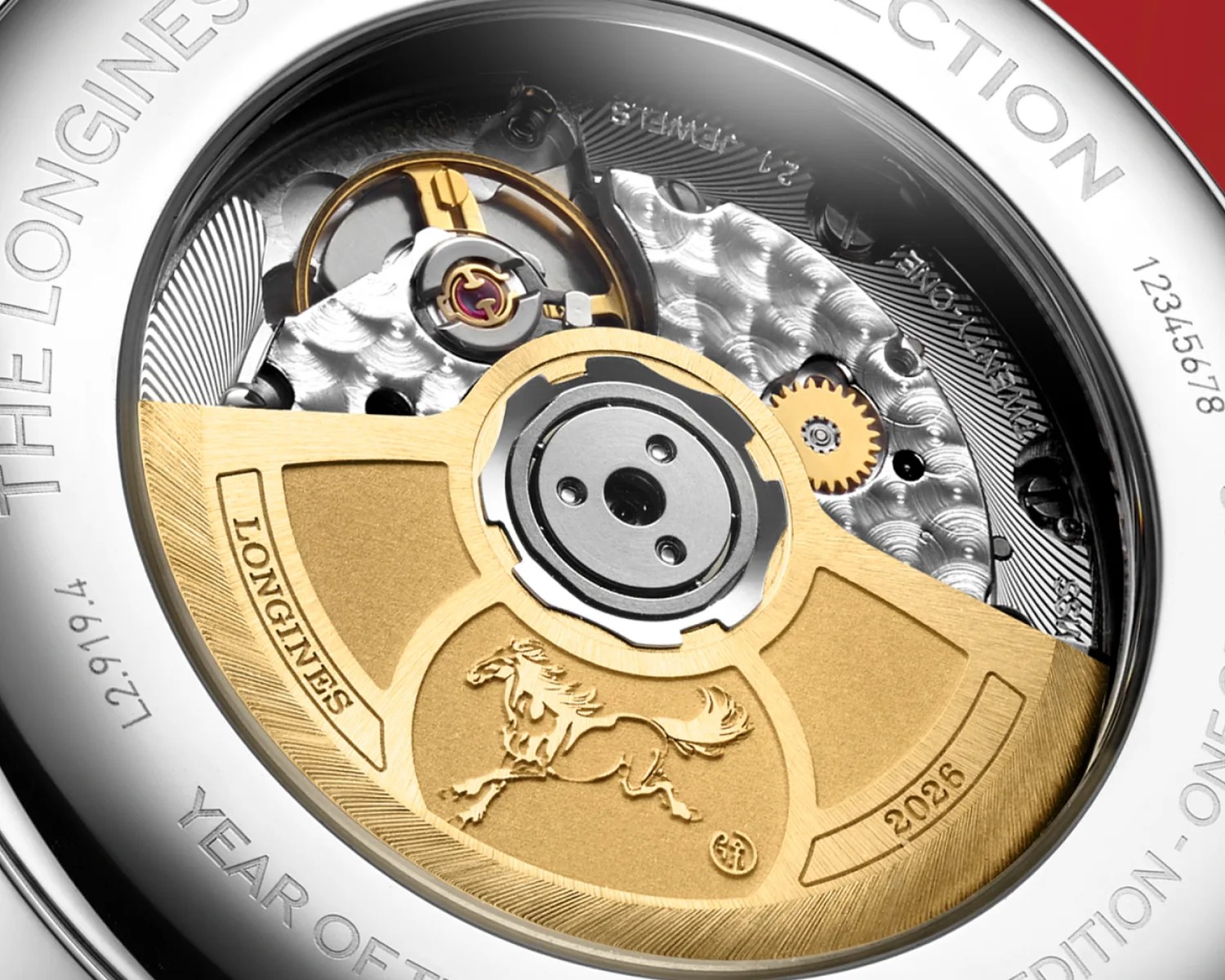Close-up of a Longines watch movement with a gold rotor engraved with a horse and the year 2026.