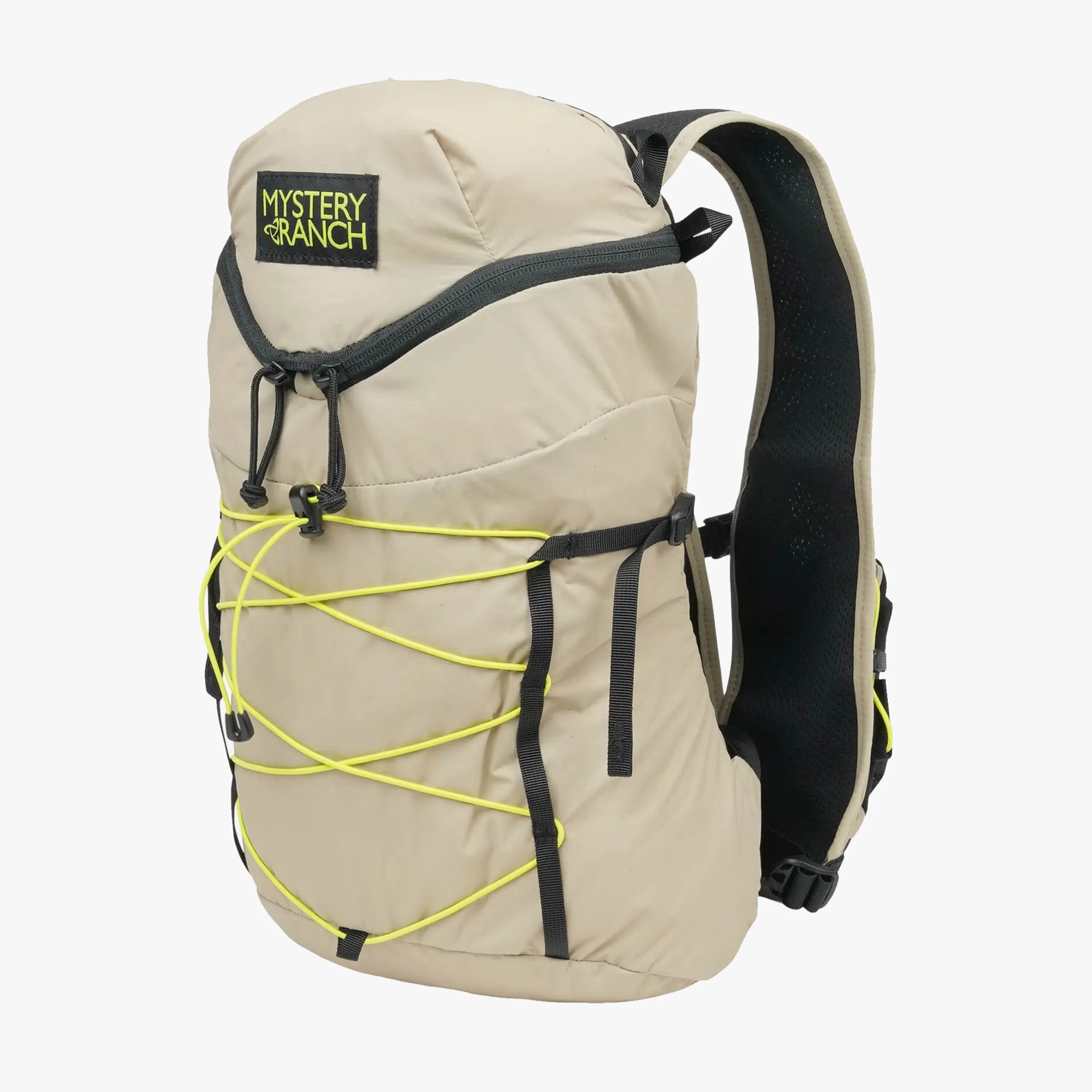 Beige Mystery Ranch backpack with black straps and neon yellow bungee cords on front.