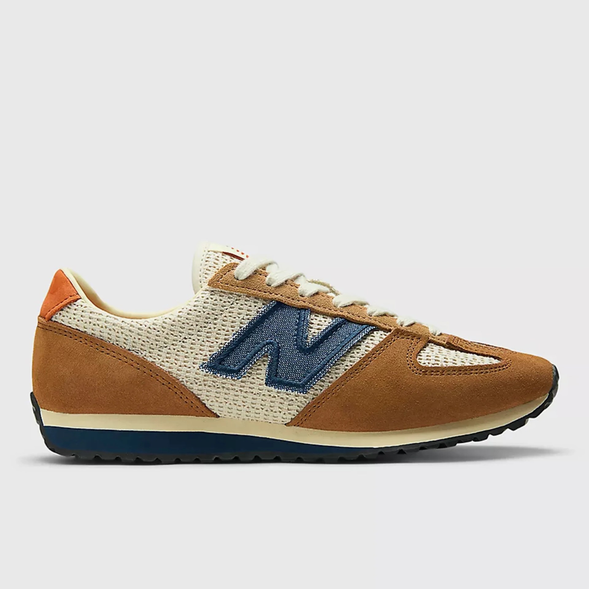 Brown suede and beige mesh sneaker with blue "N" logo and black sole.