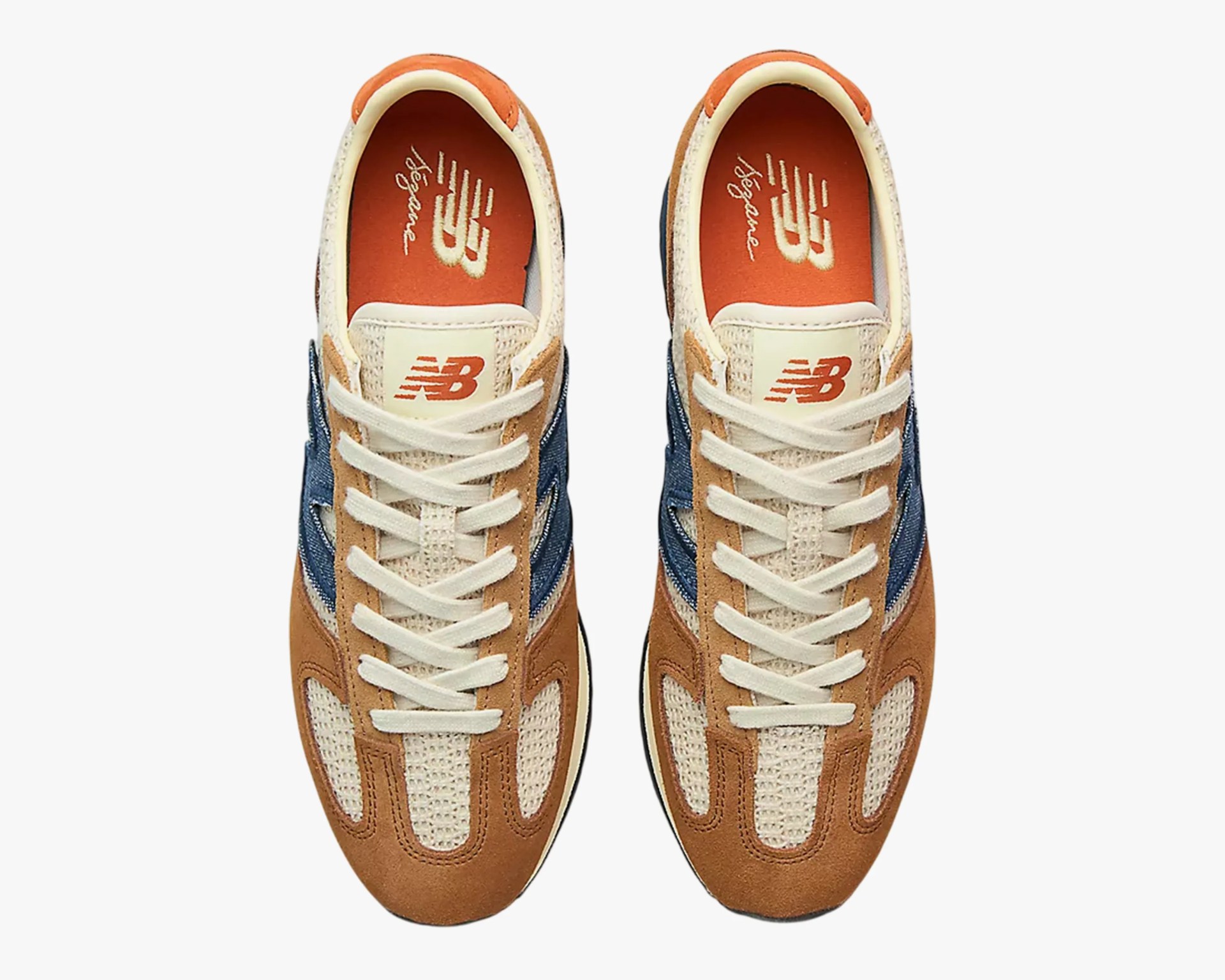 Pair of New Balance sneakers in tan suede and cream mesh with navy blue accents and white laces, viewed from above.
