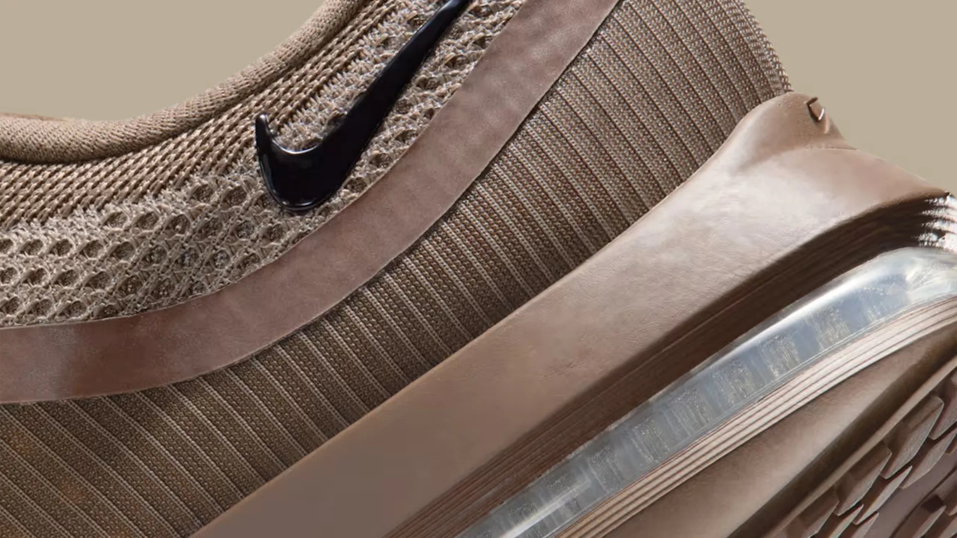 Close-up of a brown Nike sneaker with mesh upper, suede accents, and visible air cushioning in the sole.
