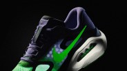 Purple and green Nike ZoomX running shoe with neon green swoosh and "Structure Plus" label on black background.
