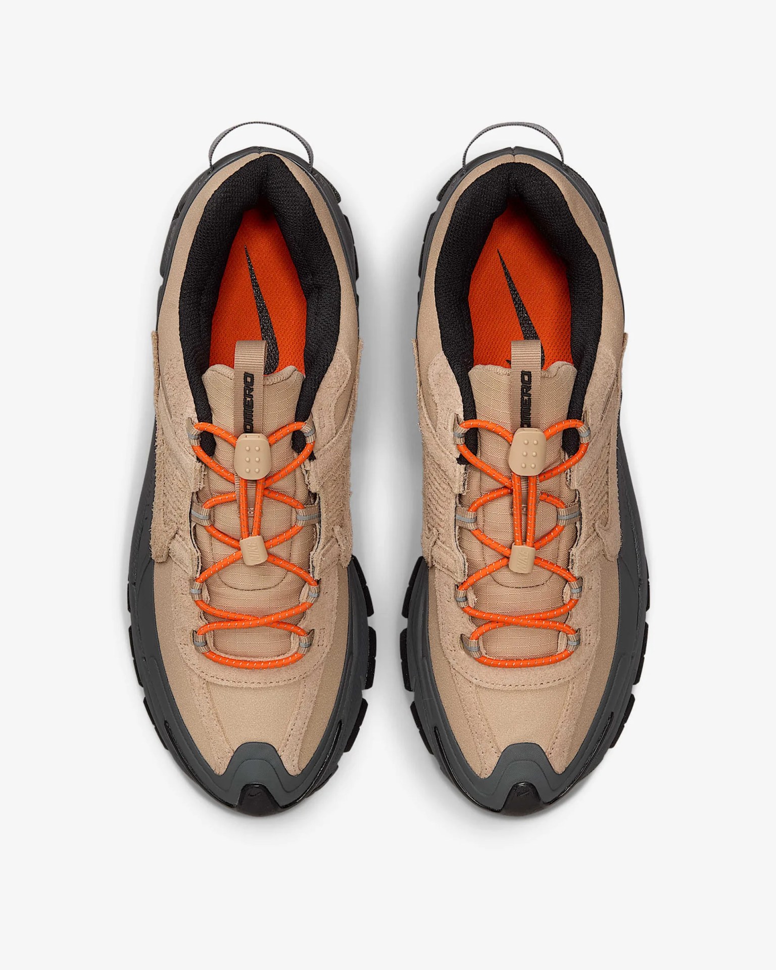 Pair of beige and black sneakers with orange laces and orange insoles featuring a black swoosh logo.