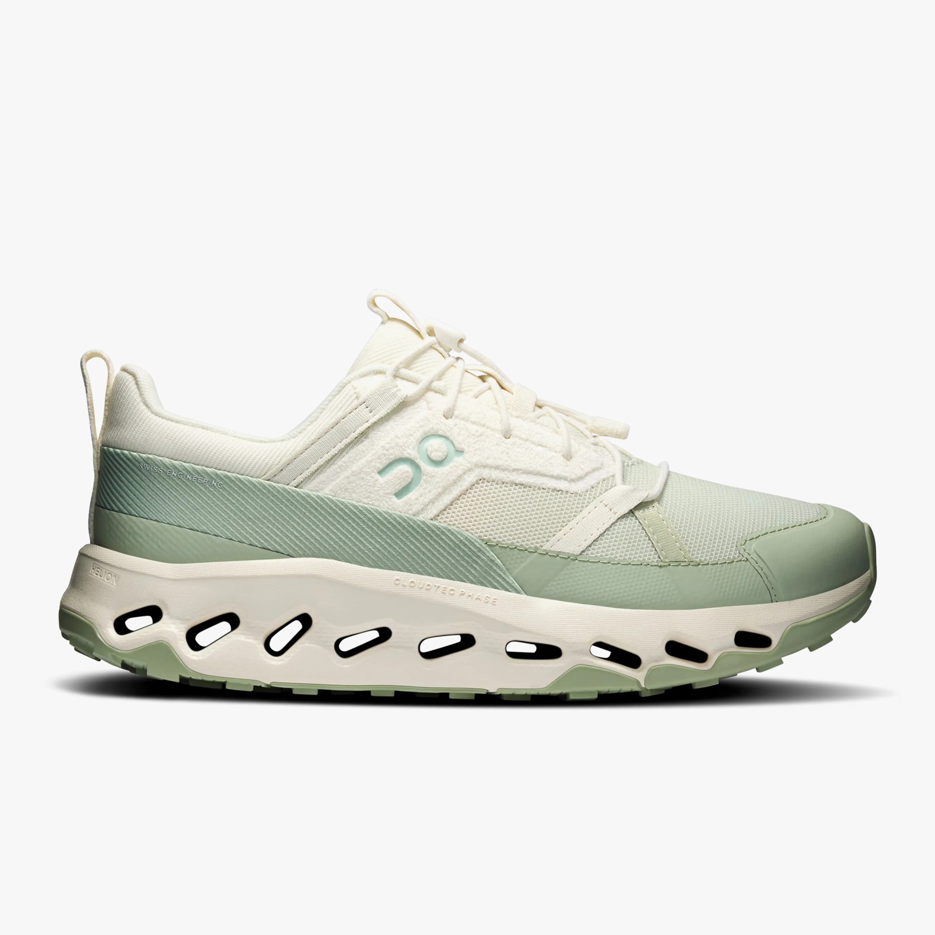 Light green and cream athletic shoe with mesh upper and thick white sole featuring black cutouts.