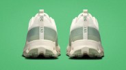 Pair of white and light green athletic shoes with "ON END" text on the heel tab against a green background.