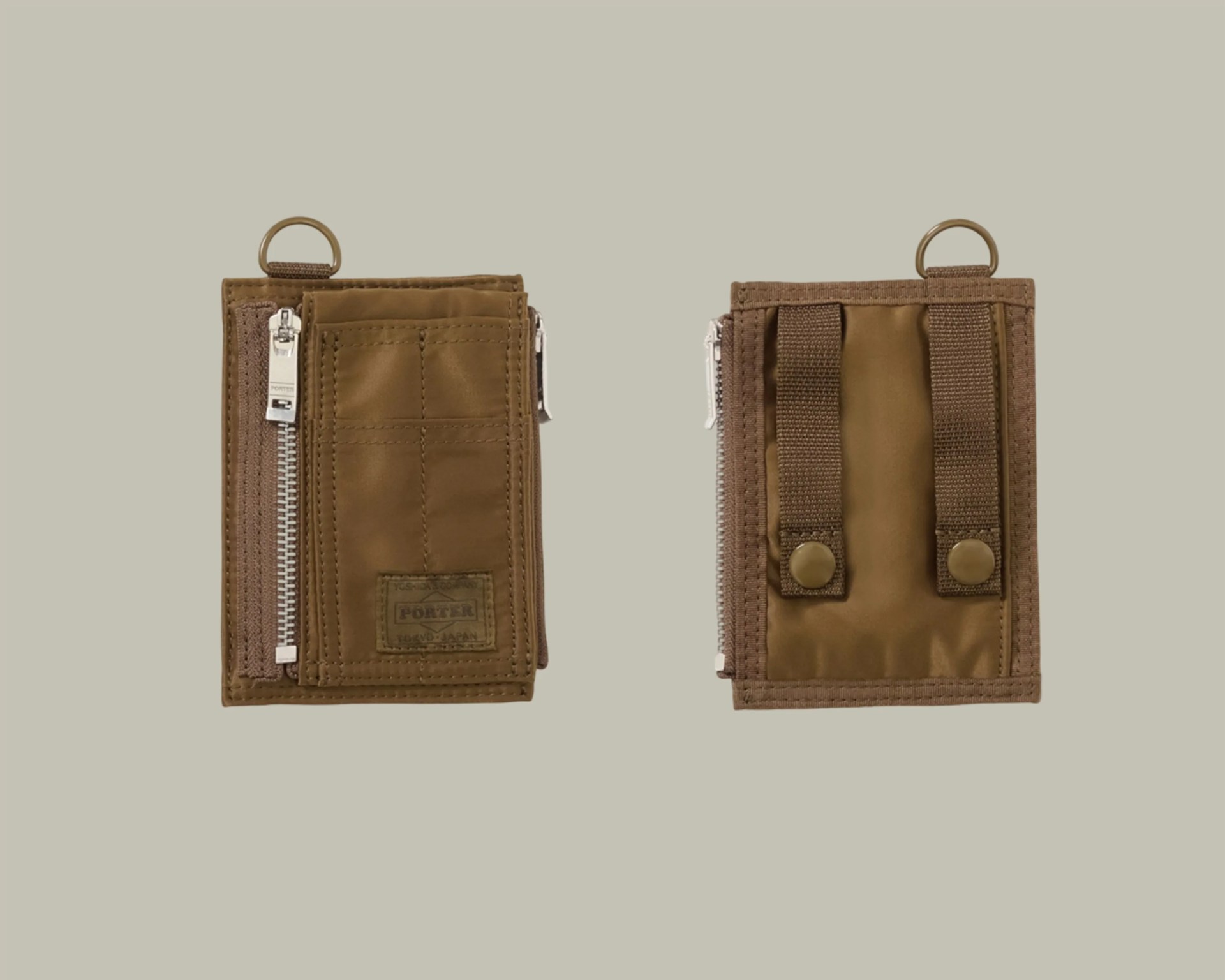 Brown nylon wallet with silver zipper and two snap-button straps on the back.