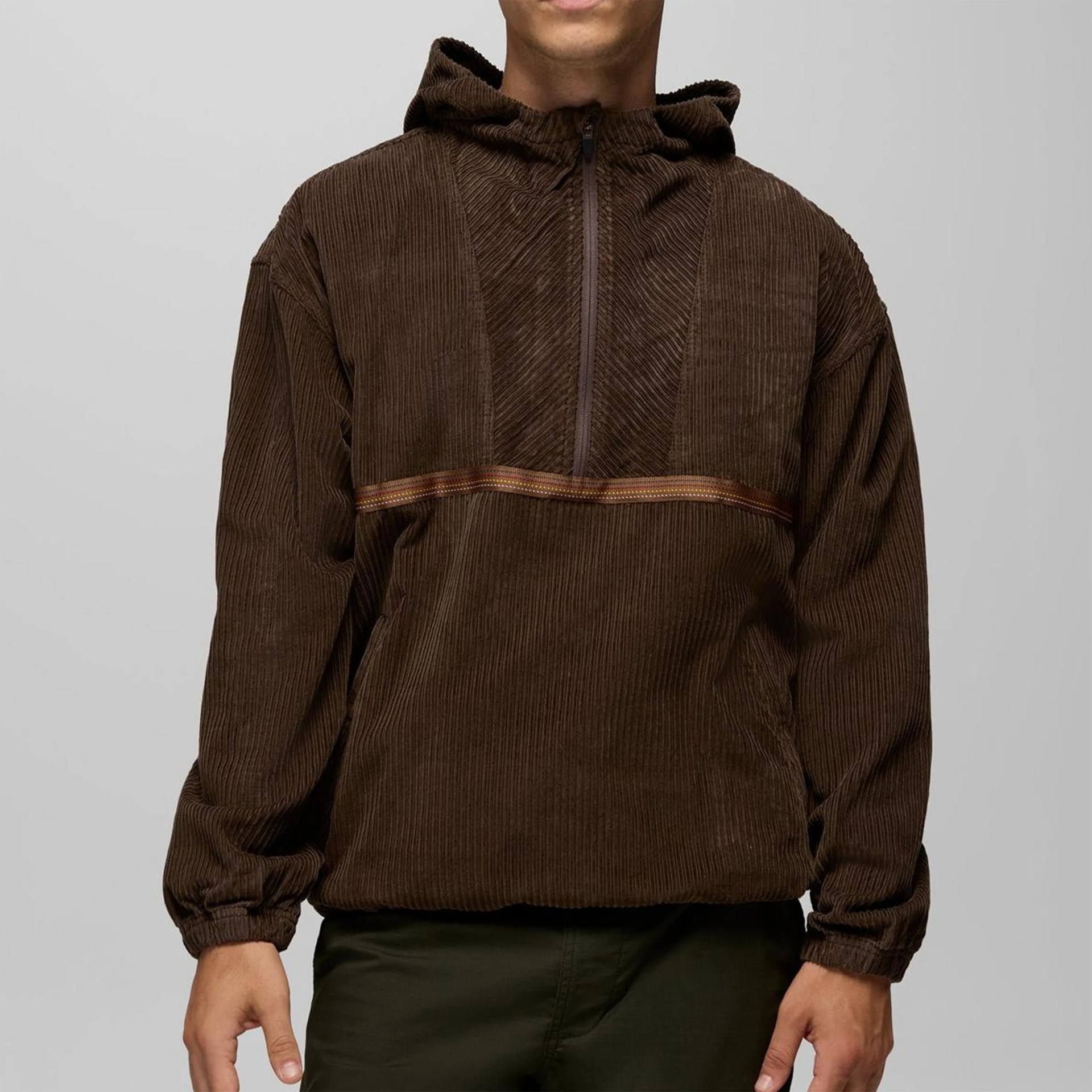 Brown corduroy pullover hoodie with half-zip and elastic cuffs worn by a person.