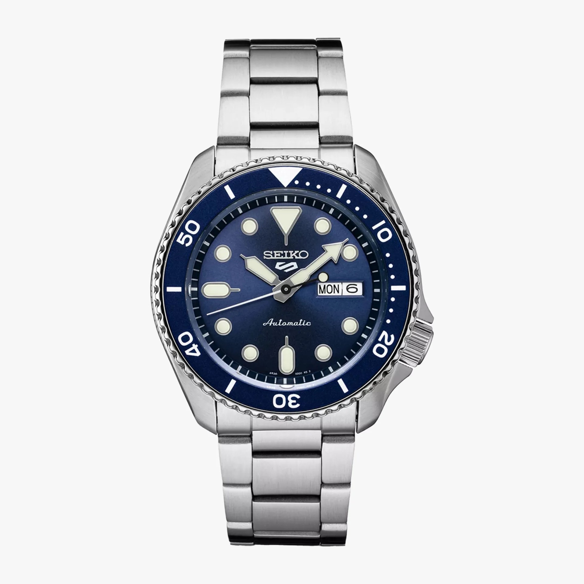 Silver stainless steel Seiko wristwatch with blue bezel and dial, luminous markers, and day-date display.