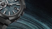 Close-up of a black Seiko Astron GPS Solar watch with a textured blue dial and silver hour markers.
