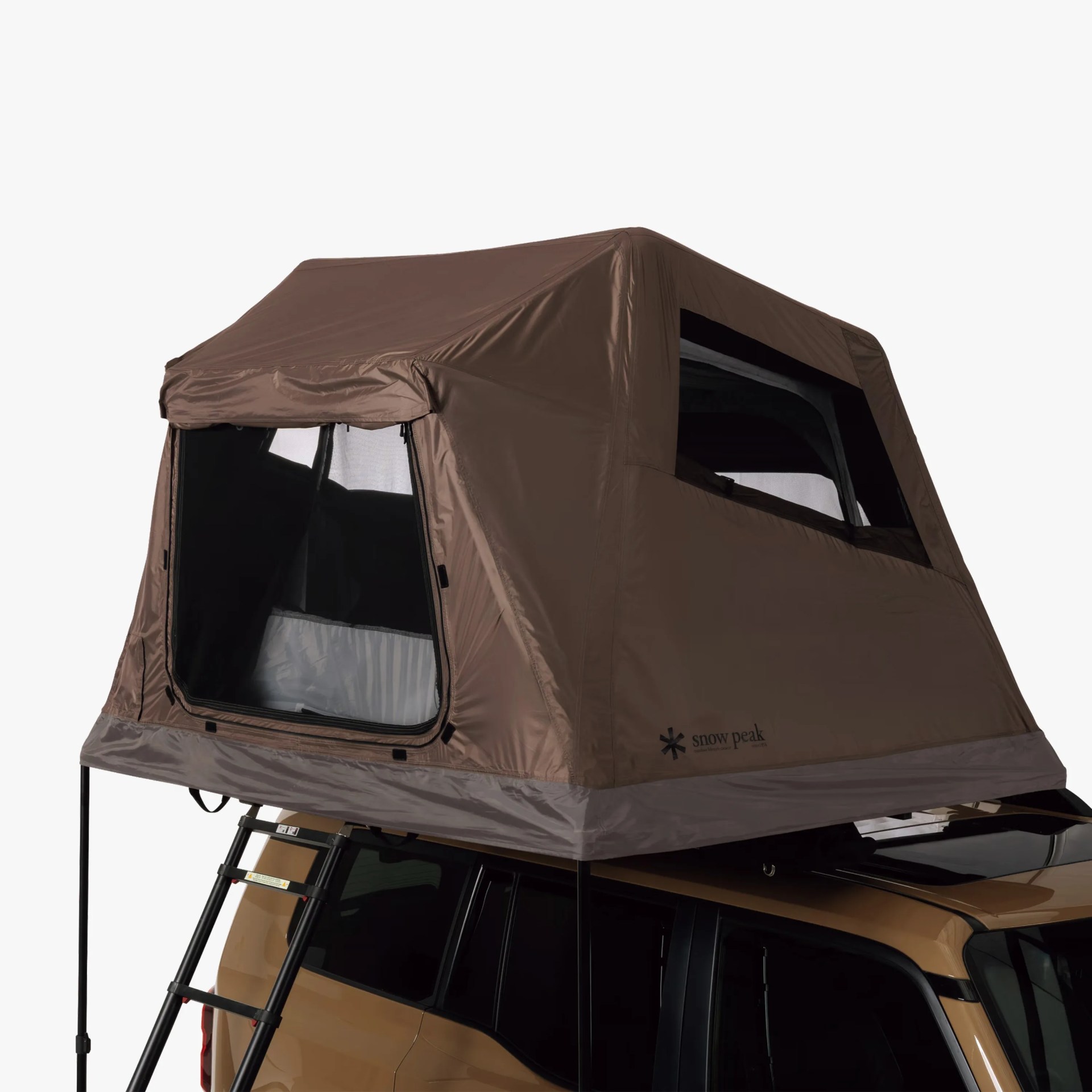 Brown rooftop tent with black mesh windows and a ladder mounted on a tan vehicle.