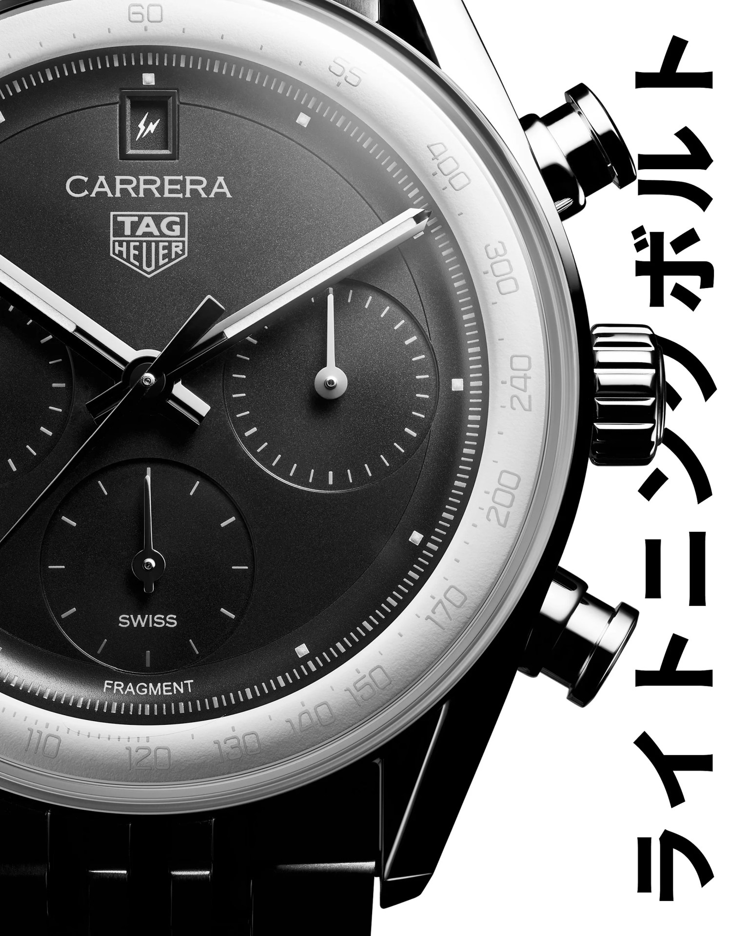 Close-up of a black TAG Heuer Carrera chronograph watch with silver hands and subdials, and Japanese text on the right.