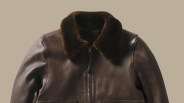 Dark brown leather jacket with a thick, plush fur collar and front zipper closure.