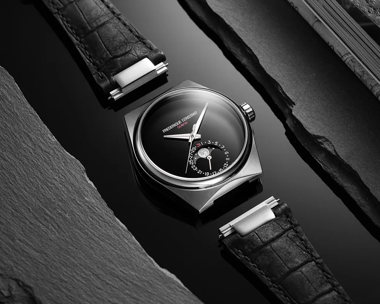 Black dial Frederique Constant wristwatch with moon phase and date subdial, black leather strap, and stainless steel case.