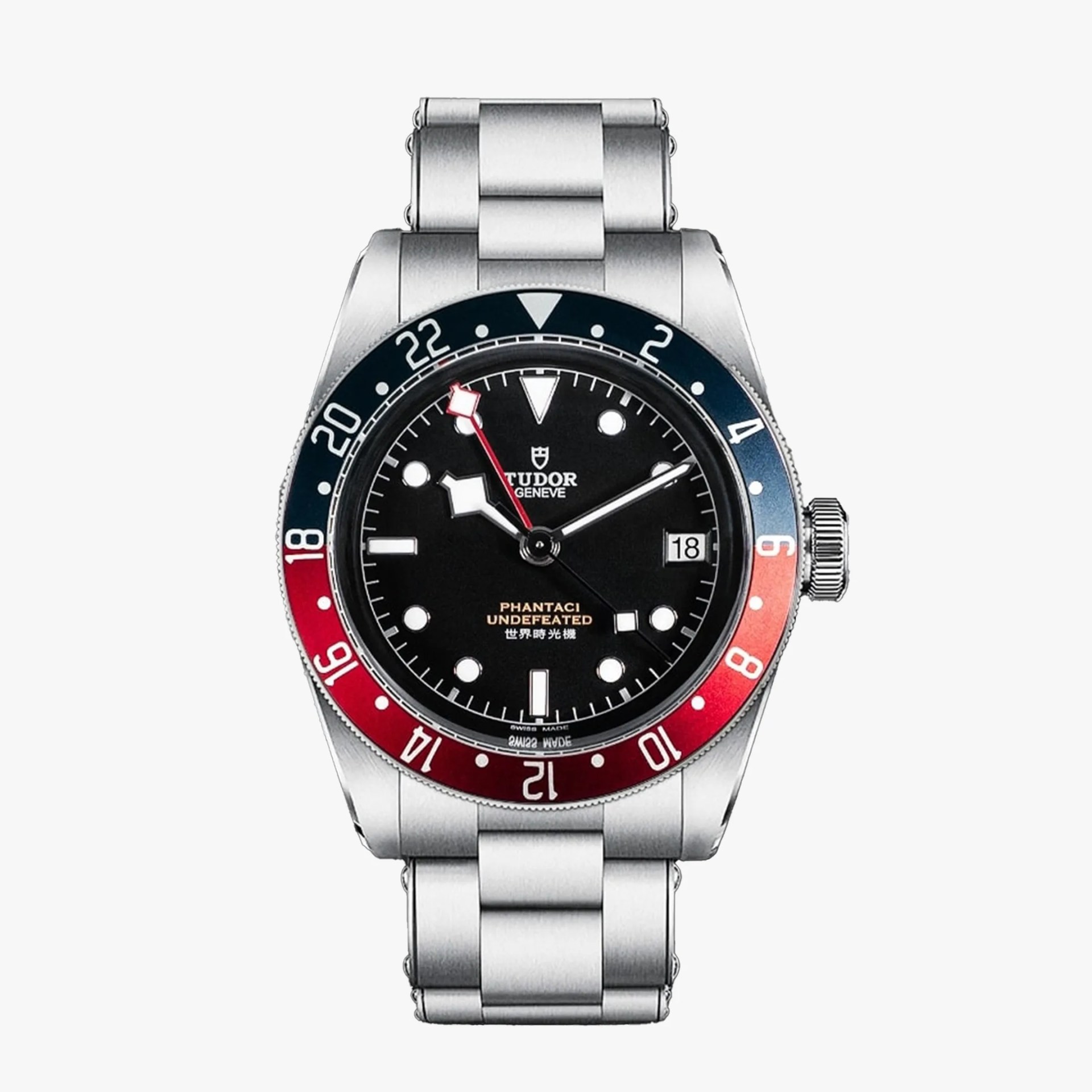 Stainless steel Tudor wristwatch with black dial, red and blue bezel, and metal link bracelet.
