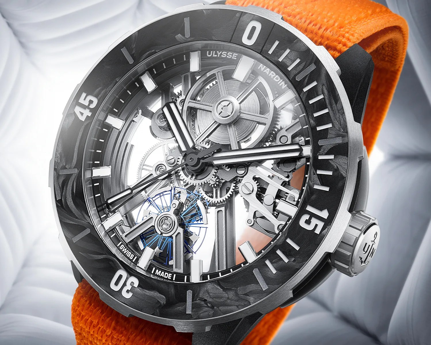 Skeleton dial Ulysse Nardin watch with visible gears, black and silver bezel, and orange fabric strap.