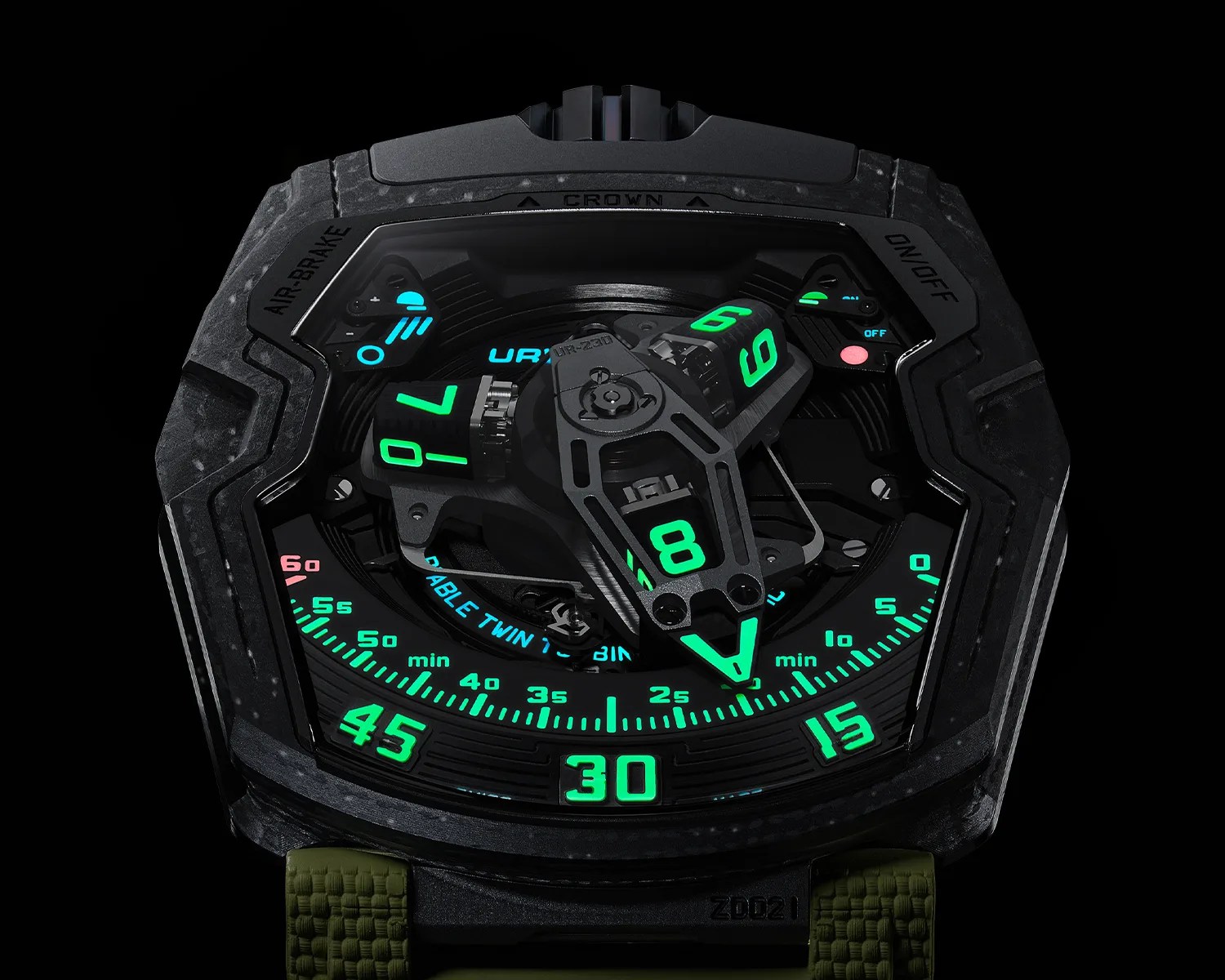 Black futuristic watch face with glowing green numerals and indicators, featuring a complex mechanical design and an olive green strap.