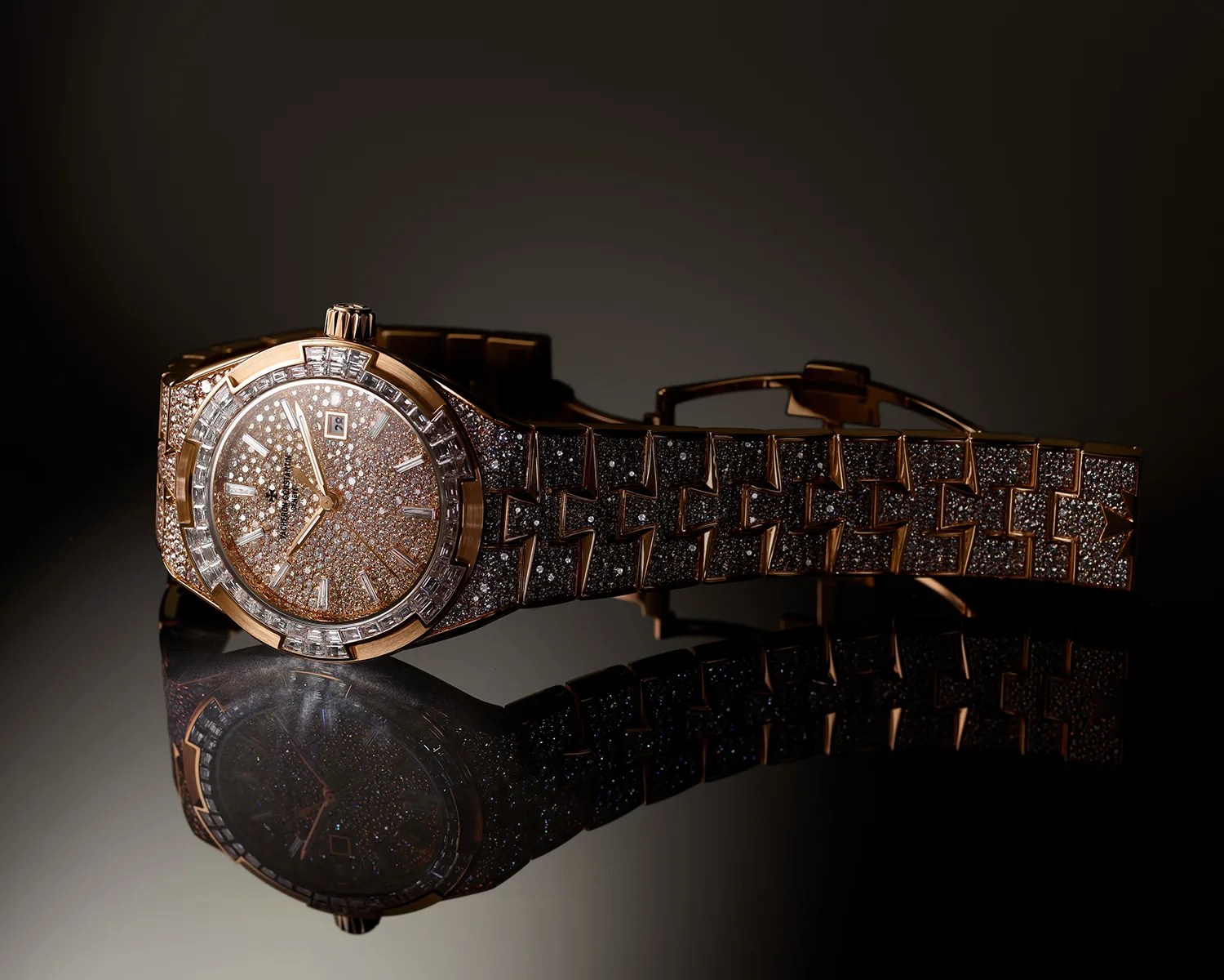 Rose gold wristwatch encrusted with diamonds on the face, bezel, and bracelet, reflected on a glossy surface.