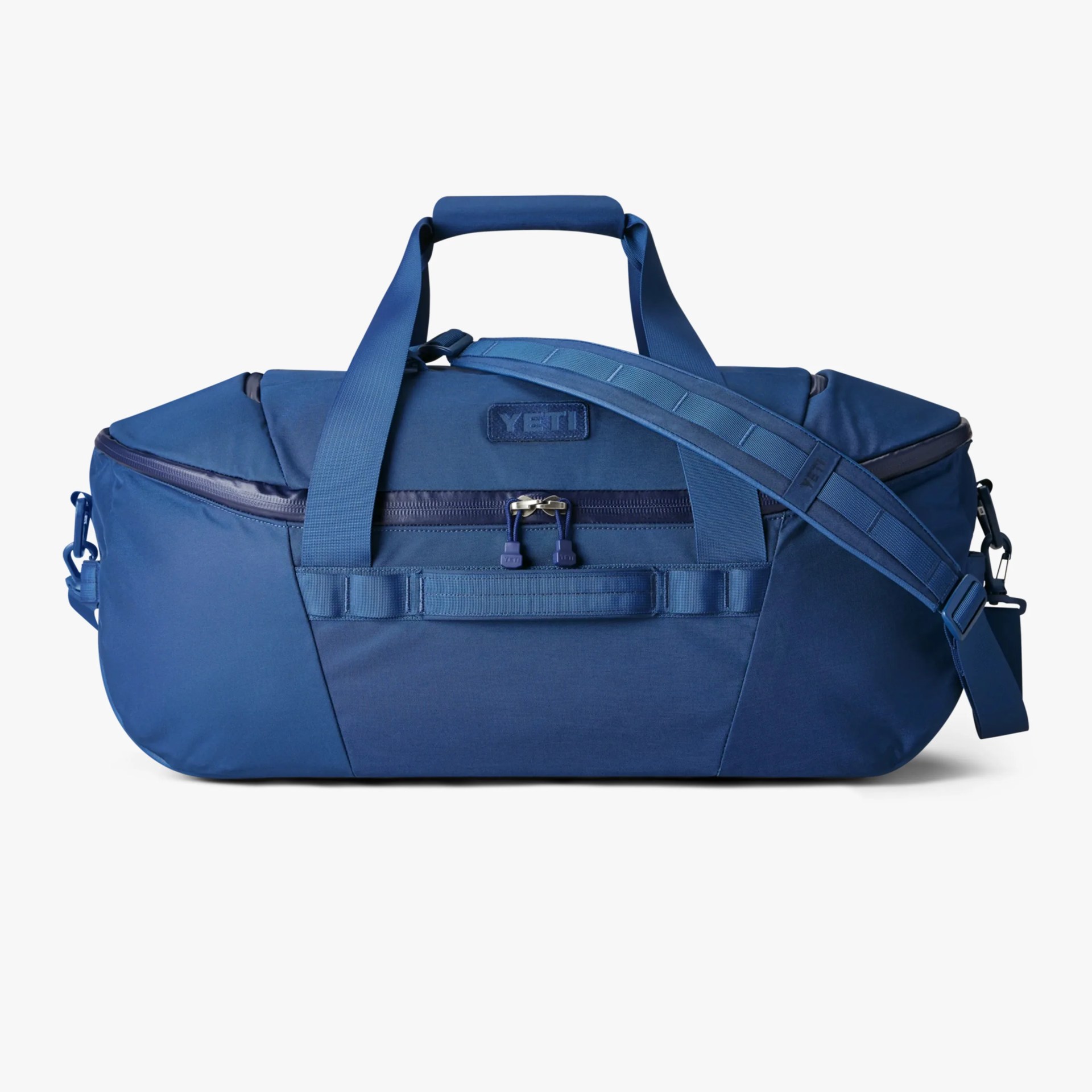 Blue YETI duffel bag with padded shoulder strap and dual handles on a white background.
