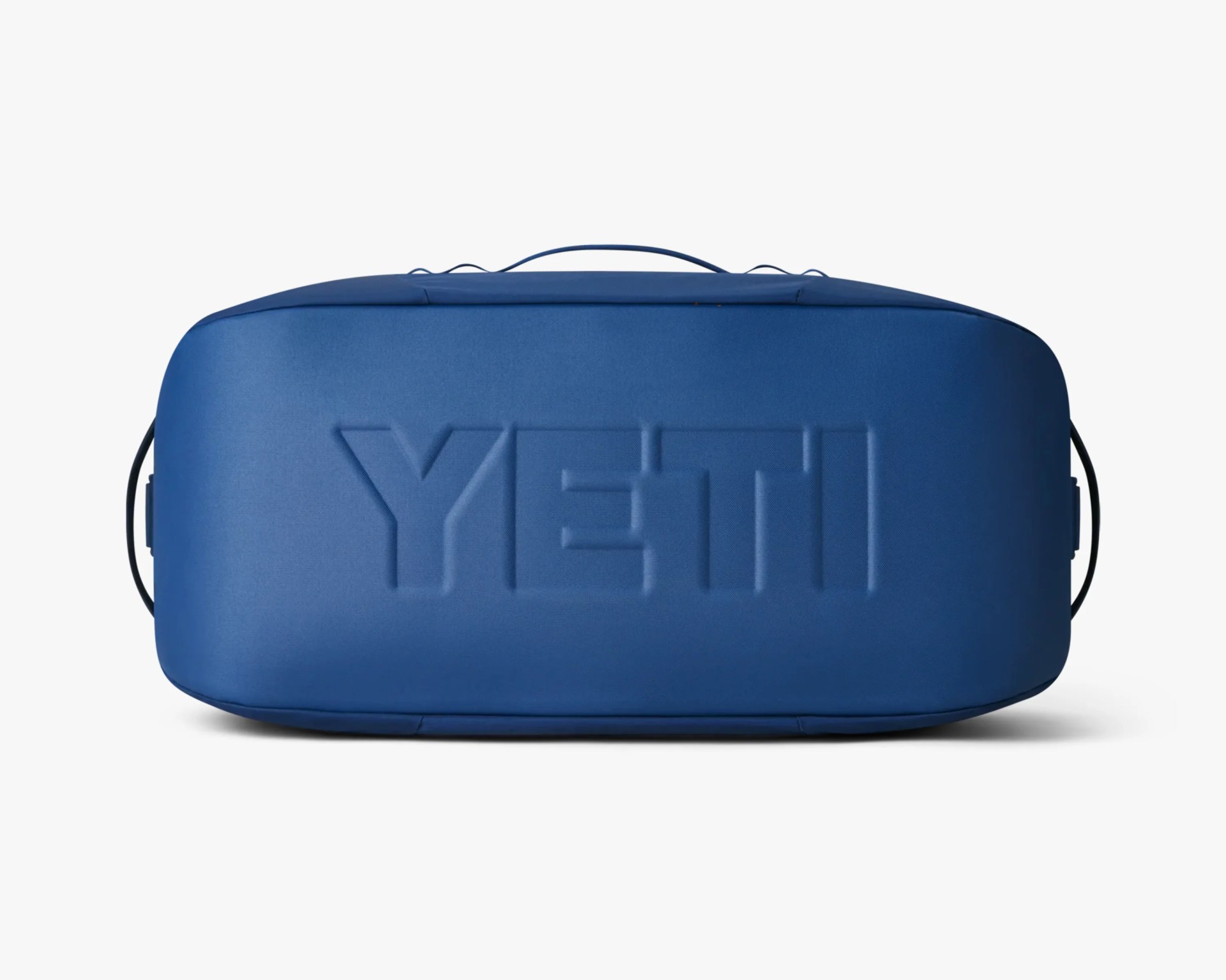 Blue rectangular soft cooler bag with embossed "YETI" logo on the front.