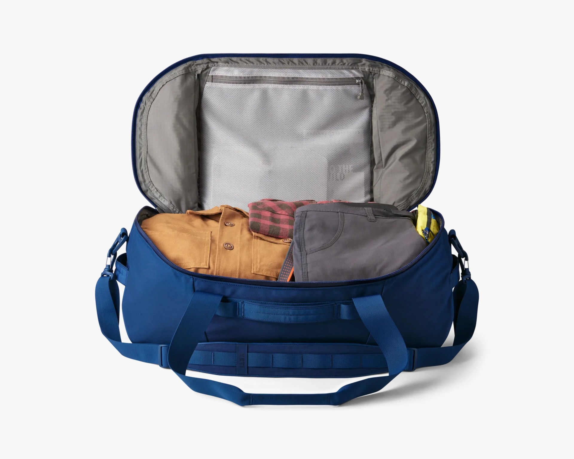 Blue duffel bag open with folded clothes inside and a zippered mesh pocket on the lid.