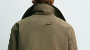 Olive-green jacket with a raised collar viewed from the back.