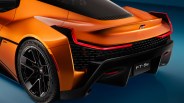 Rear side view of an orange Toyota GR FT-Se sports car with black diffuser and Michelin tires.