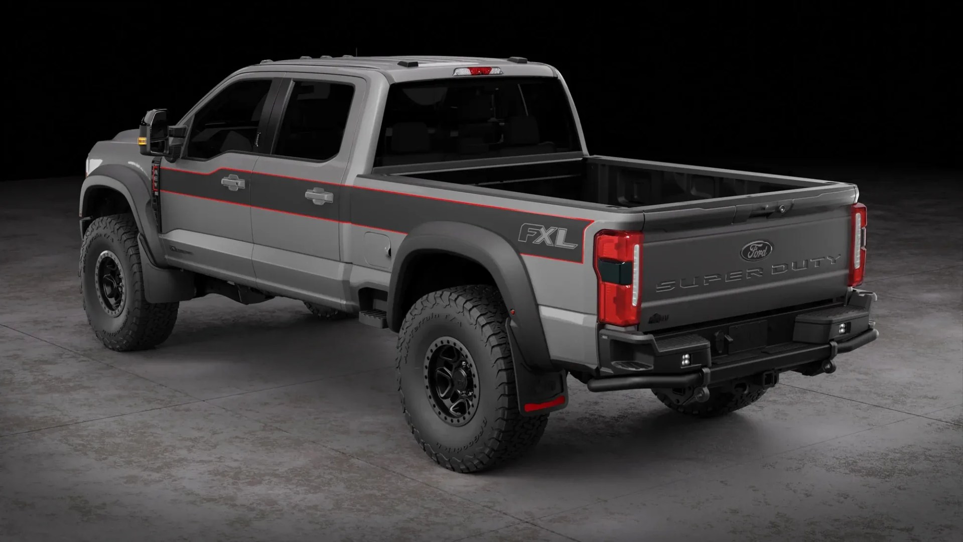 Gray Ford Super Duty FXL pickup truck with black and red stripe detailing, shown from rear side angle.
