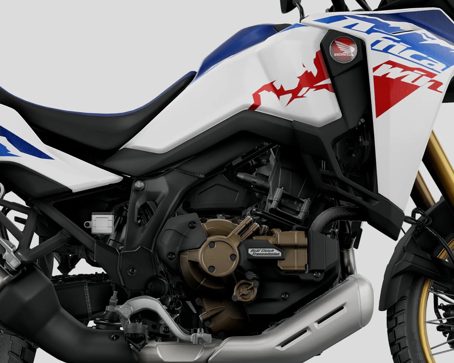 Close-up of a white, blue, and red Honda motorcycle engine with "Dual Clutch Transmission" label and black seat.
