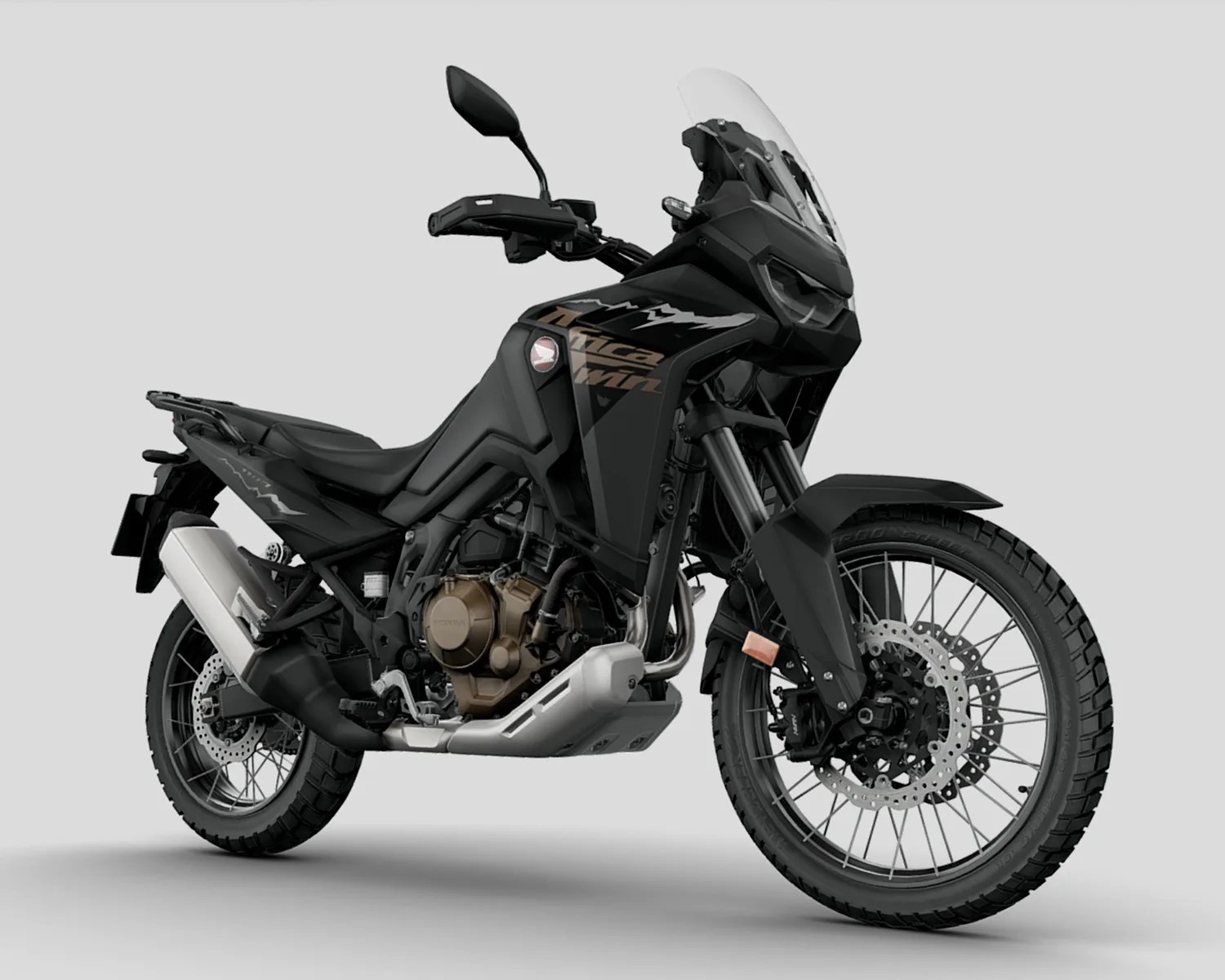 Black Honda Africa Twin adventure motorcycle with bronze engine casing and clear windshield on a gray background.