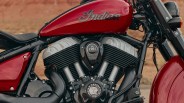 Close-up of a red Indian motorcycle fuel tank and black engine with "est. 1901" and Indian Motorcycle logo.