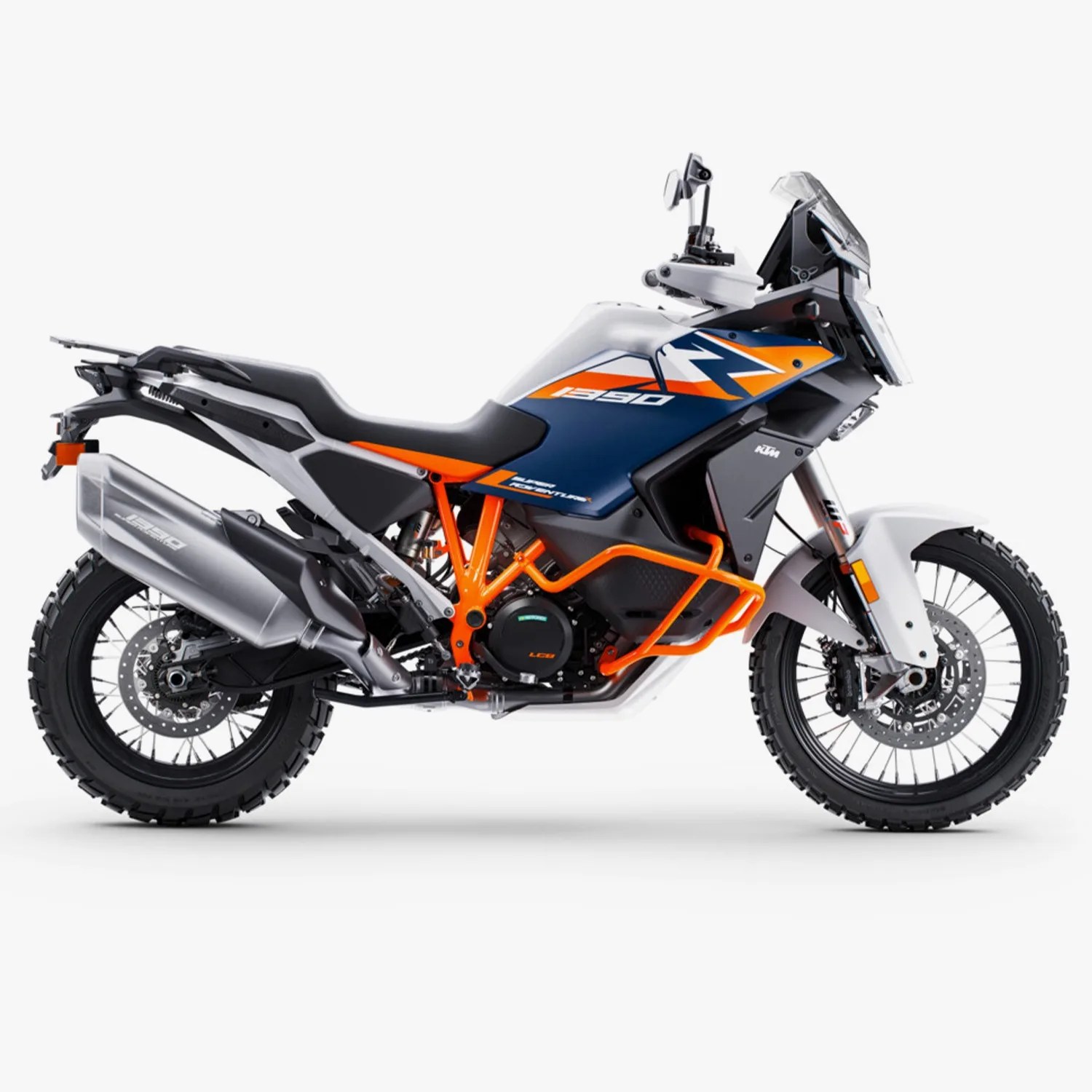 White, blue, and orange KTM 1290 Adventure R motorcycle with knobby tires and orange frame guards.