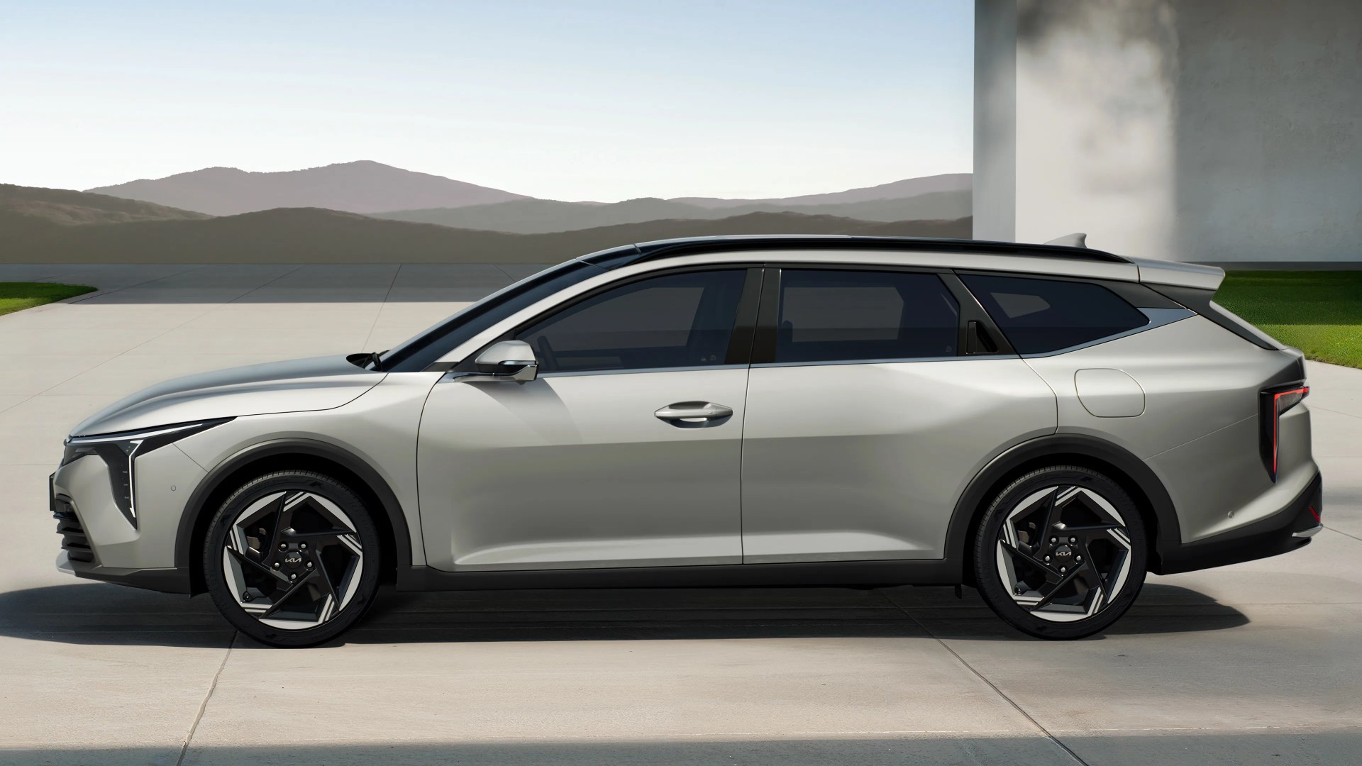 Silver modern station wagon with black trim and geometric alloy wheels parked on a concrete surface.