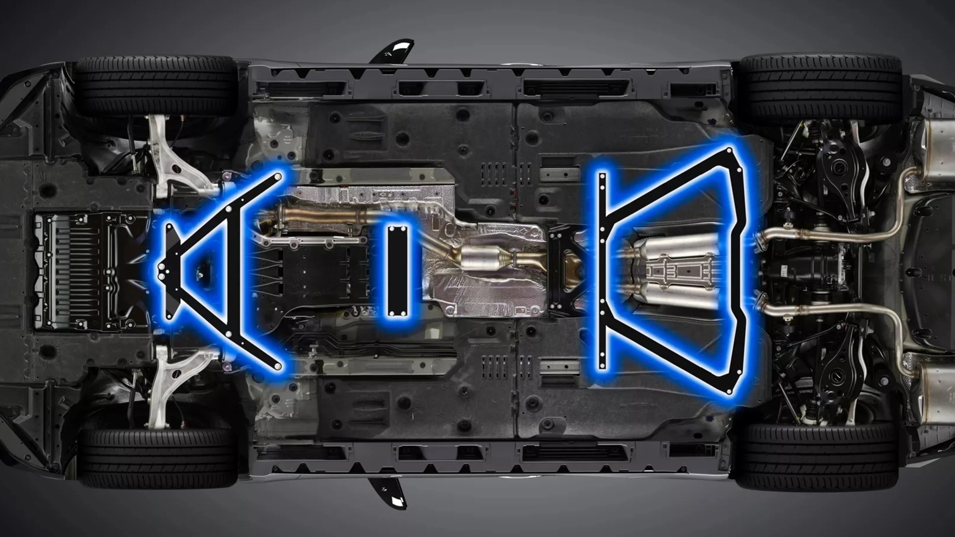 Underside of a car chassis showing suspension components highlighted with blue outlines.