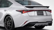 Rear view of a white Lexus IS 500 with black multi-spoke wheels, quad exhaust tips, and F Sport Parts badge.